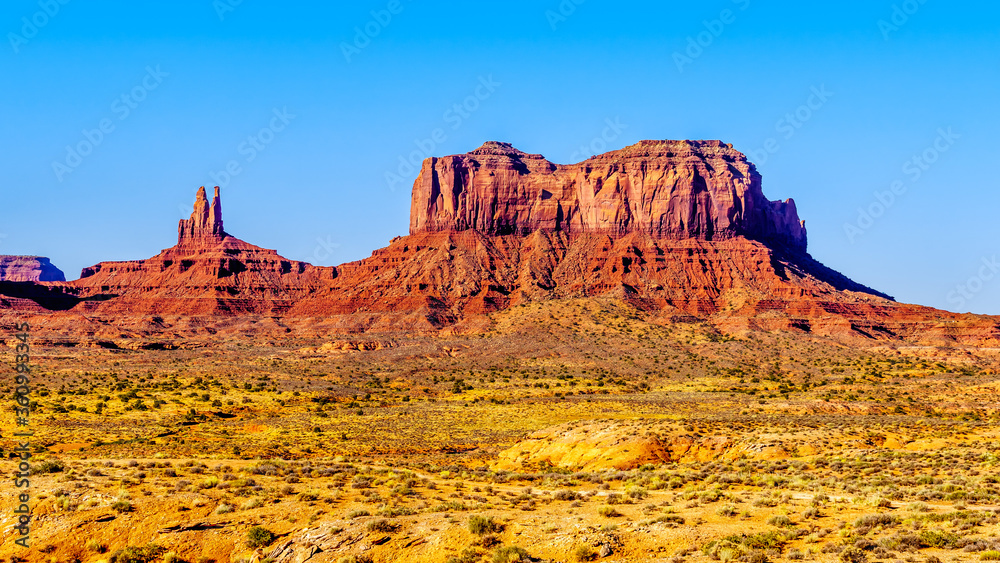 The towering sandstone Buttes and Mesas of Big Indian Butte and Sentinel Mesa in the Navajo Nation's Monument Valley Navajo Tribal Park on the border of Arizona and Utah, United States The towering sandstone Buttes and Mesas of Big Indian Butte and Sentinel Mesa in the Navajo Nation's Monument Valley Navajo Tribal Park on the border of Arizona and Utah, United States