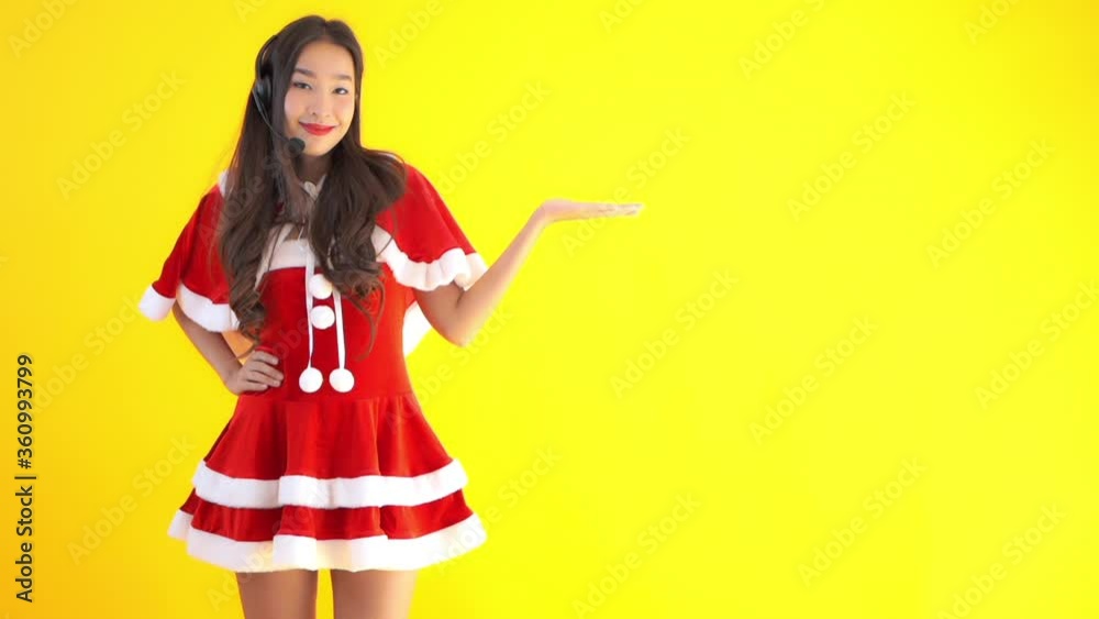 Joyful Asian girl wearing Christmas costume poses in front of camera, chroma key Joyful Asian girl wearing Christmas costume poses in front of camera, chroma key