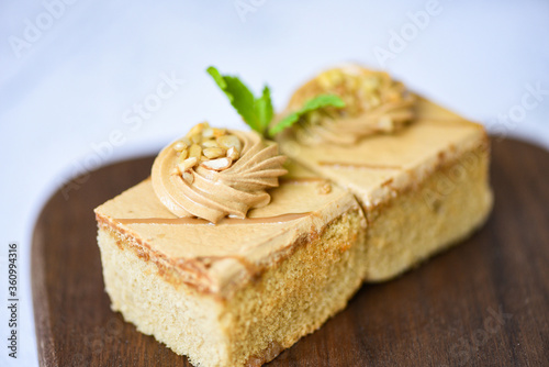 coffee cake delicious dessert with mint leaf and nuts topping on wooden /