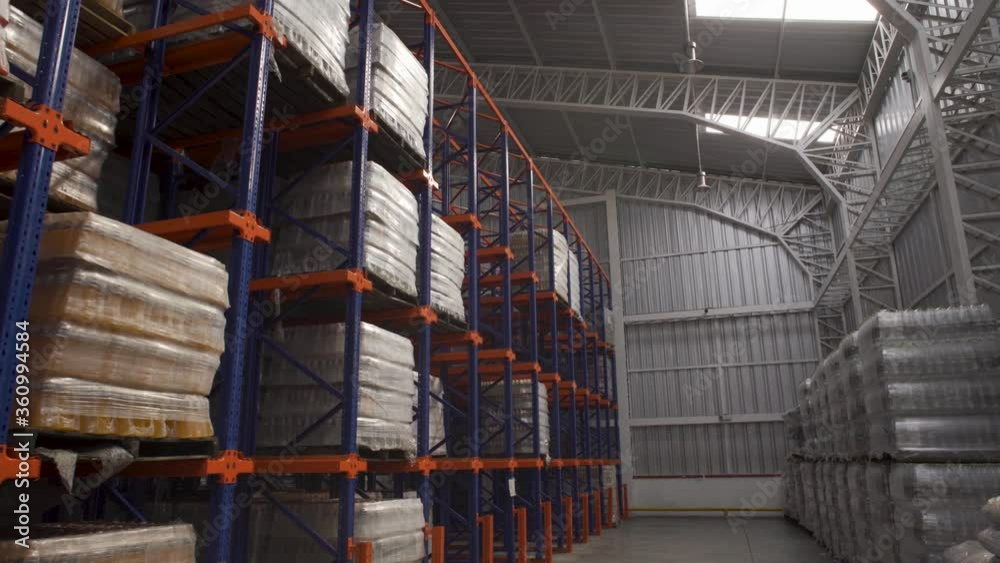 Rows of shelves with boxes Inside Of Modern warehouse, dolly in. Rows of shelves with boxes Inside Of Modern warehouse, dolly in.
