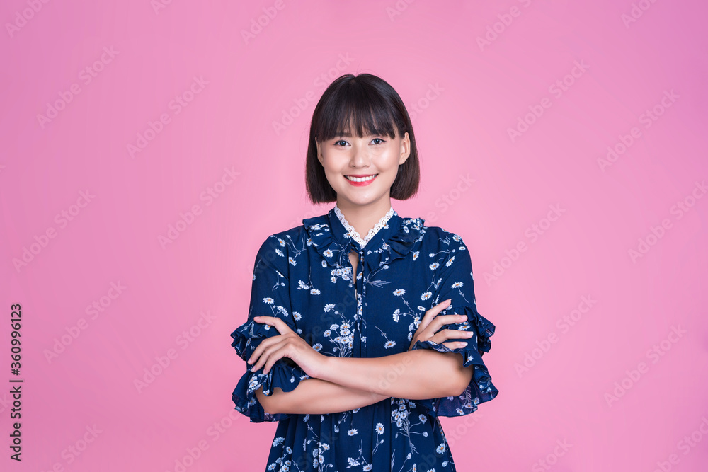 Asian attractive cute short hair woman happy smiling arms crossed confident independent strong mother businesswoman wearing casual dress pink isolated background in studio portrait looking into camera Asian attractive cute short hair woman happy smiling arms crossed confident independent strong mother businesswoman wearing casual dress pink isolated background in studio portrait looking into camera