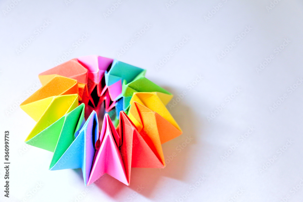 Colorful rainbow origami on studio white background. Fun, indoor summertime activity with kids.