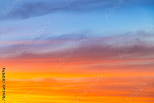 Amazing blue, orange and yellow colors sunset sky gradient background © Roman