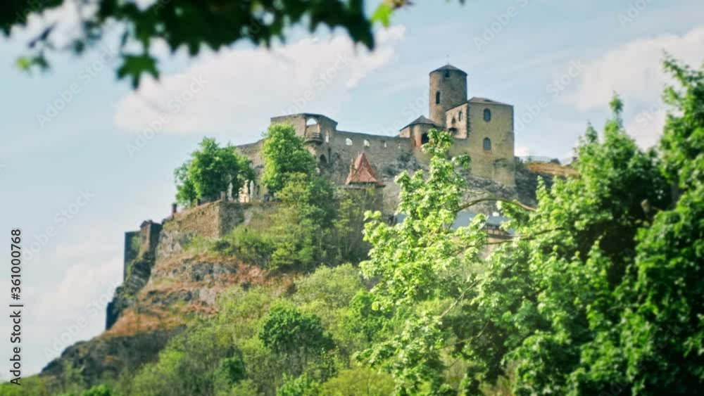 Strekov castel in Bohemia during spring in a fairytale atmosphere with branches of trees moved by the breeze