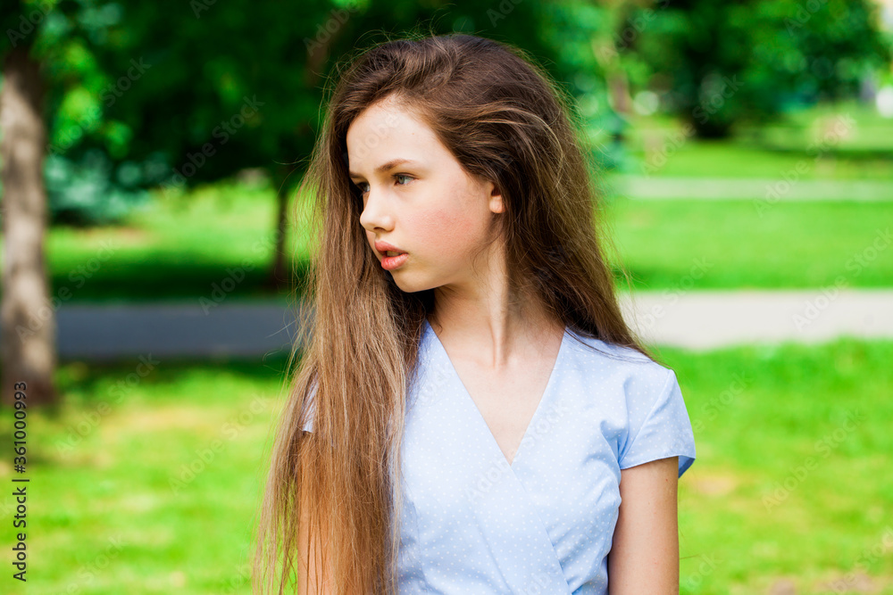 Portrait of a young beautiful brunette girl in summer park Portrait of a young beautiful brunette girl in summer park