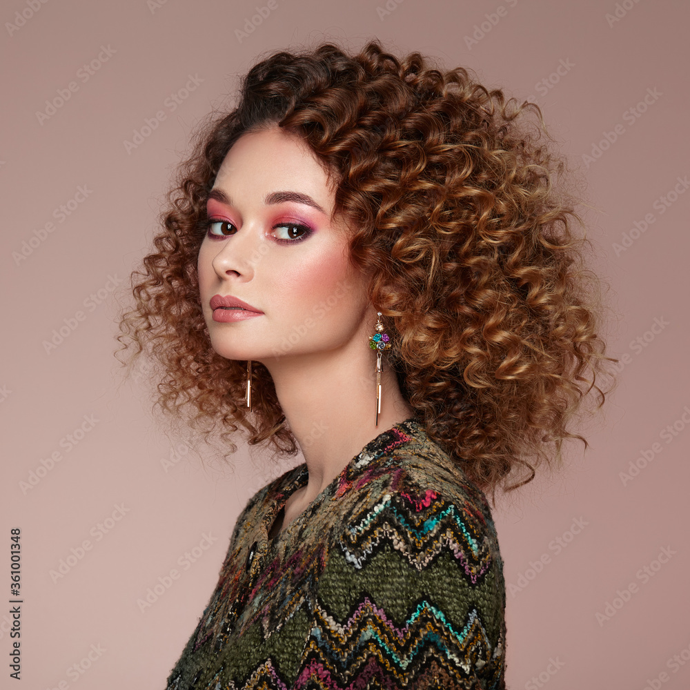 Fototapeta premium Beautiful woman in a jacket. Perfect makeup. Beauty fashion. Cosmetic. Eyeshadow. Elegant afro curly hairstyle