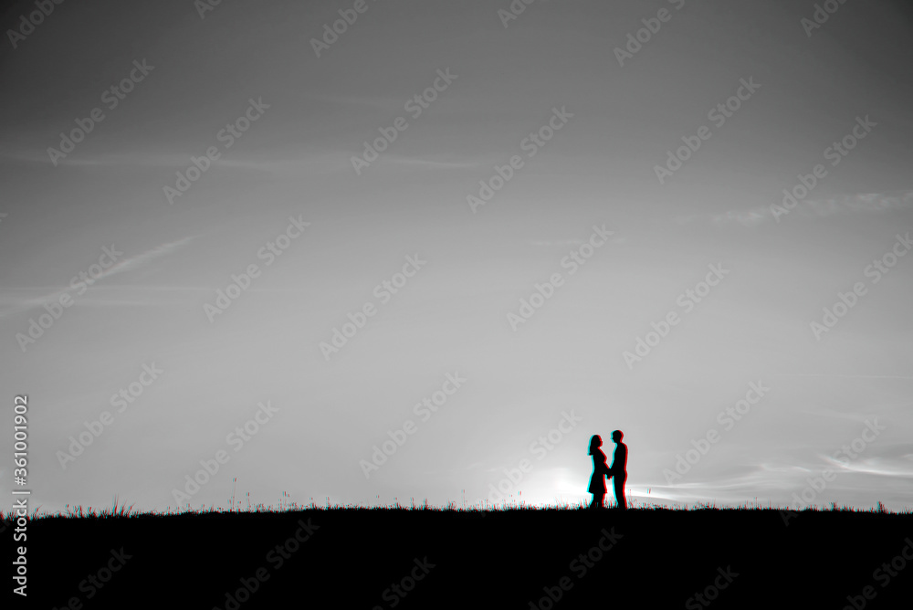 silhouette of a couple in love hugging together