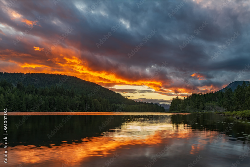 Amazing orange sunset over lake with reflection at Inland Lake Provincial Park on the sunshine coast near Powell River on Inland Lake Provincial park. Amazing orange sunset over lake with reflection at Inland Lake Provincial Park on the sunshine coast near Powell River on Inland Lake Provincial park.