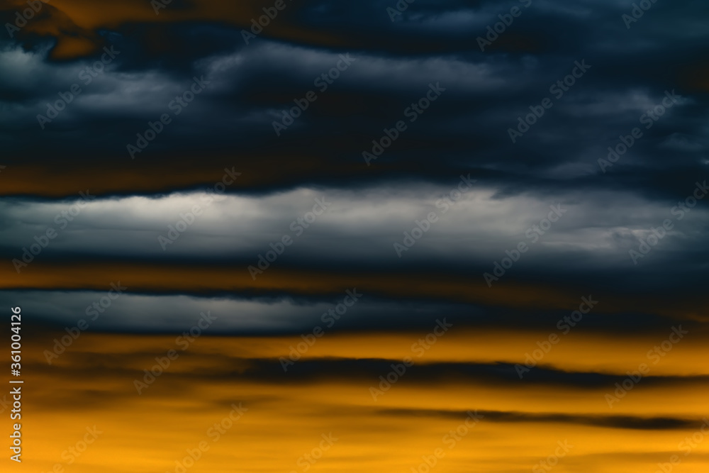Fototapeta premium Dramatic sunset sky with dark thunderstorms clouds