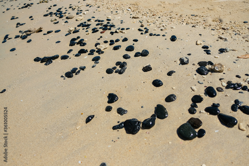 the black stones on the sandy beach.. the black stones on the sandy beach..