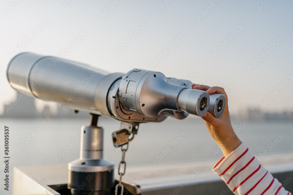 telescope with city skyline