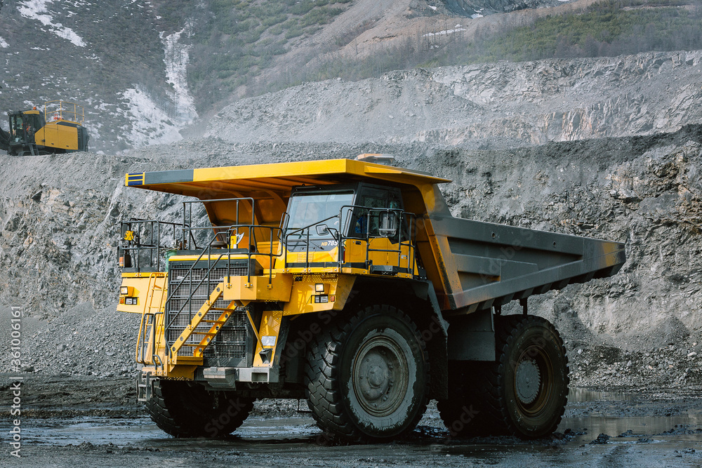 A career dump truck is in the career. A career dump truck is in the career.