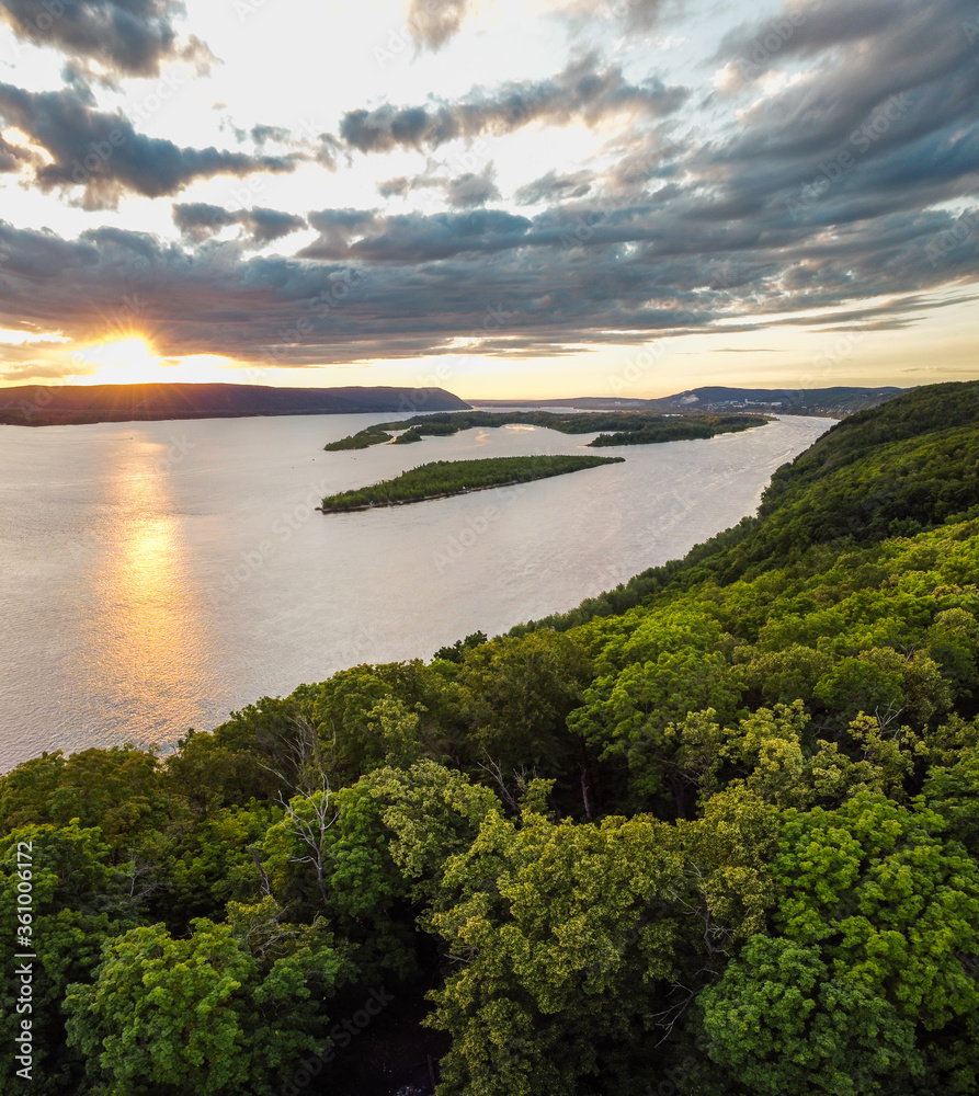 Aerial landscape view on Volga river with small sand islands and green forest on hills during summer sunset, Samara, Russia 