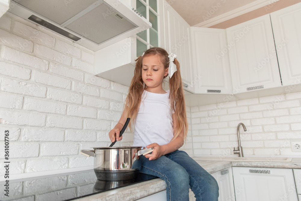 beautiful little girl with a pan and the ladle beautiful little girl with a pan and the ladle