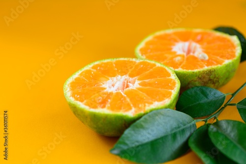 Orange juice isolated on yellow background. © Siwapot Narukietmont