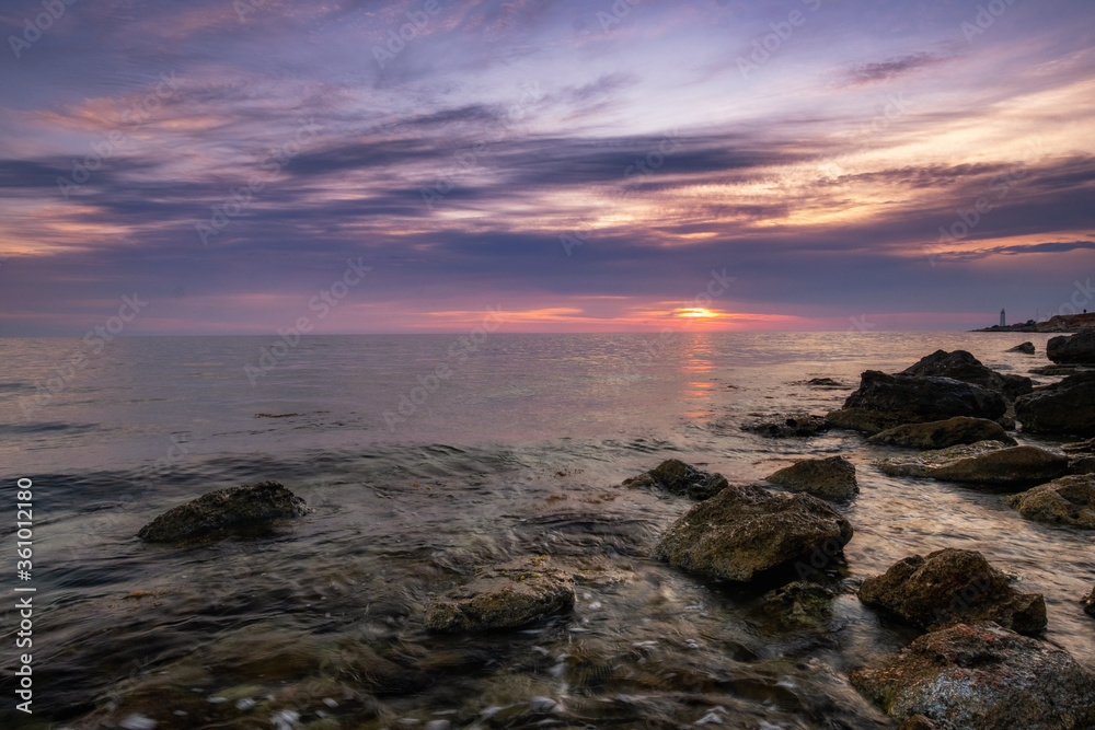 Dramatic sunset over beach with a natural pond in the foreground. Dramatic sunset over beach with a natural pond in the foreground.