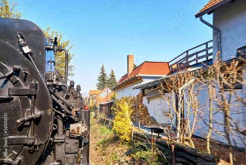 Steam locomotive drives through a residential area in Wernigerode. Dynamic due to motion blur.