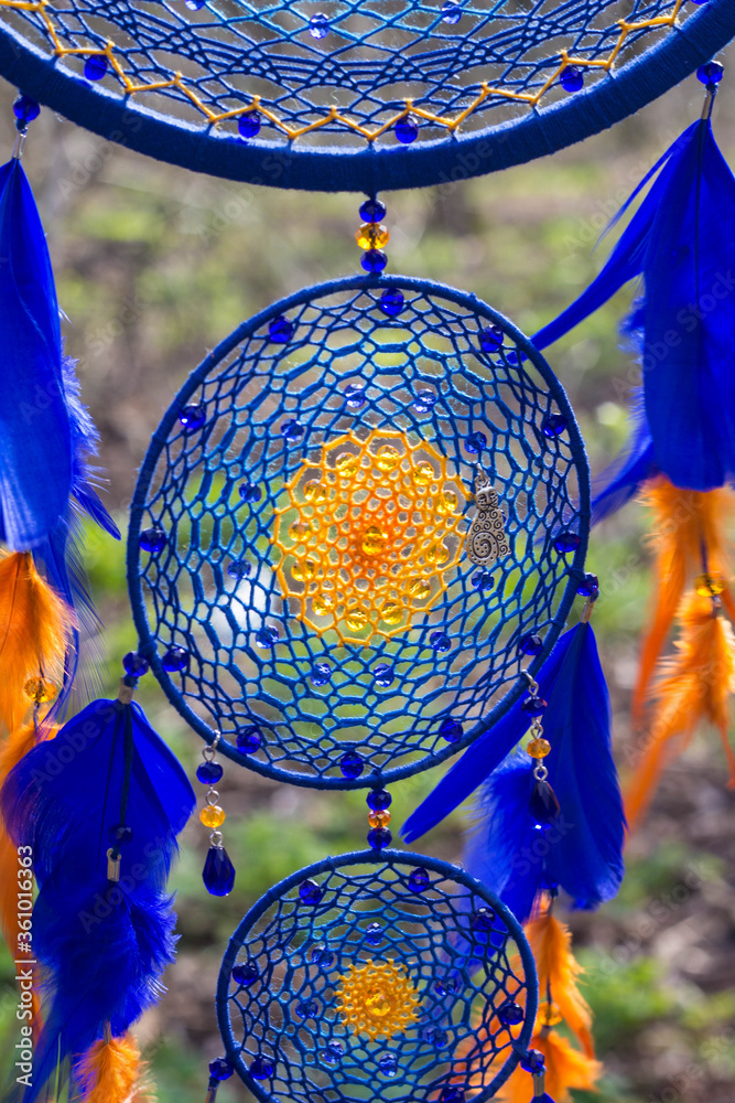 Obraz premium Handmade dream catcher with feathers threads and beads rope hanging