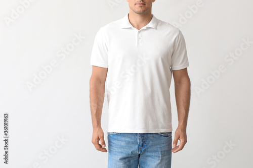 Young man in stylish t-shirt on light background