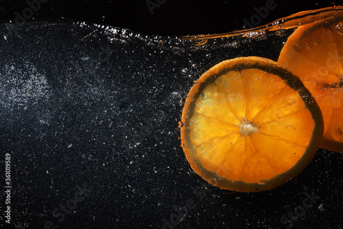 Water drops on ripe sweet orange. Fresh mandarin background with copy space for your text. Vegetarian concept. photo