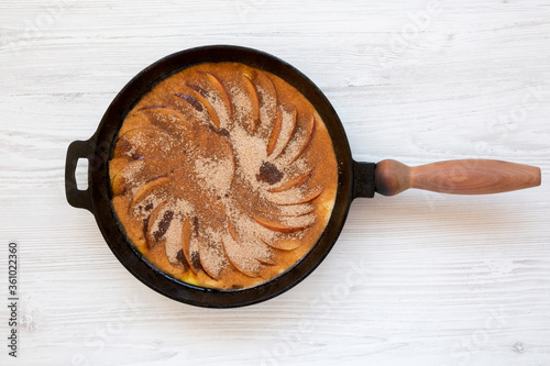 Cooking Apple Dutch Pannekoek Pancake on a white wooden background, top view. Overhead, from above, flat lay. photo