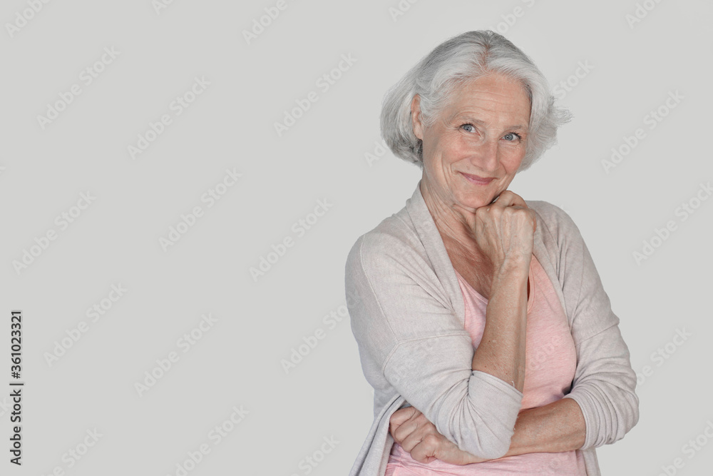 Portrait of senior woman with hand on chin, isolated Portrait of senior woman with hand on chin, isolated