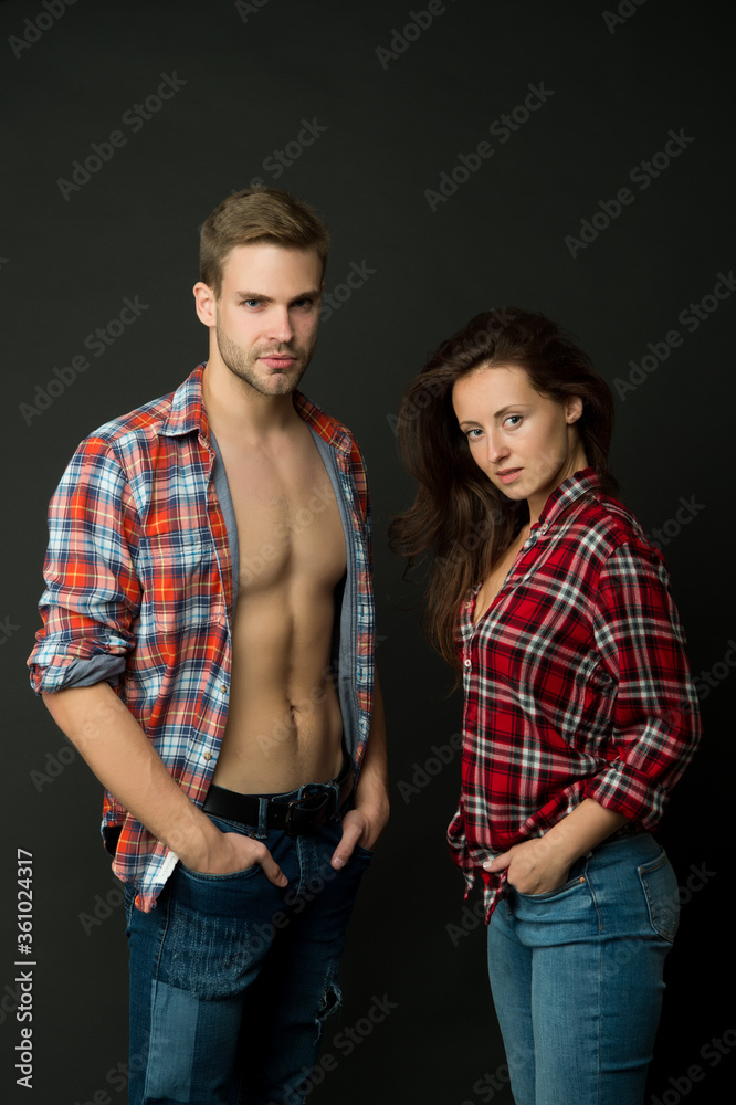 Family look. Fashion trend. Fashionable outfit. Woman and man wear checkered shirt. Sexy stylish couple black background. Young family couple. Summer fashion collection. Beautiful people concept Family look. Fashion trend. Fashionable outfit. Woman and man wear checkered shirt. Sexy stylish couple black background. Young family couple. Summer fashion collection. Beautiful people concept
