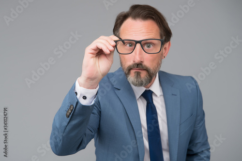 Serious businessman. Education for adults. Self education. Teacher lecturer speaker. Intelligent concept. Hard to answer. Difficult question. Perplexedly removes glasses. Business education photo