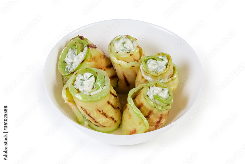 Rolls of grilled vegetable marrow with filling in bowl Rolls of grilled vegetable marrow with filling in bowl