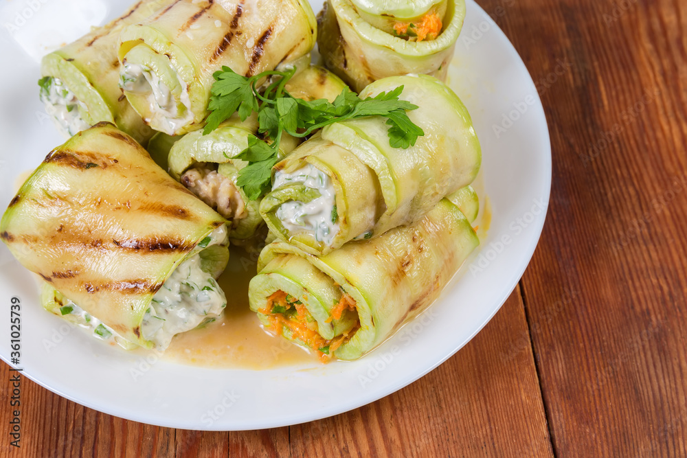 Zucchini rolls with different filling on rustic table close-up Zucchini rolls with different filling on rustic table close-up