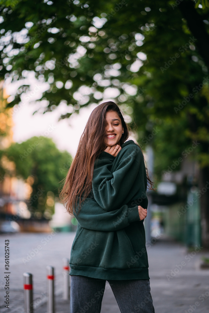 Portrait of cute girl with long hair looks at the camera