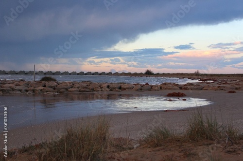 Fototapeta Naklejka Na Ścianę i Meble -  Playa de Cubelles con atardecer de fondo / Cubelles beach with a sunrise in the background 