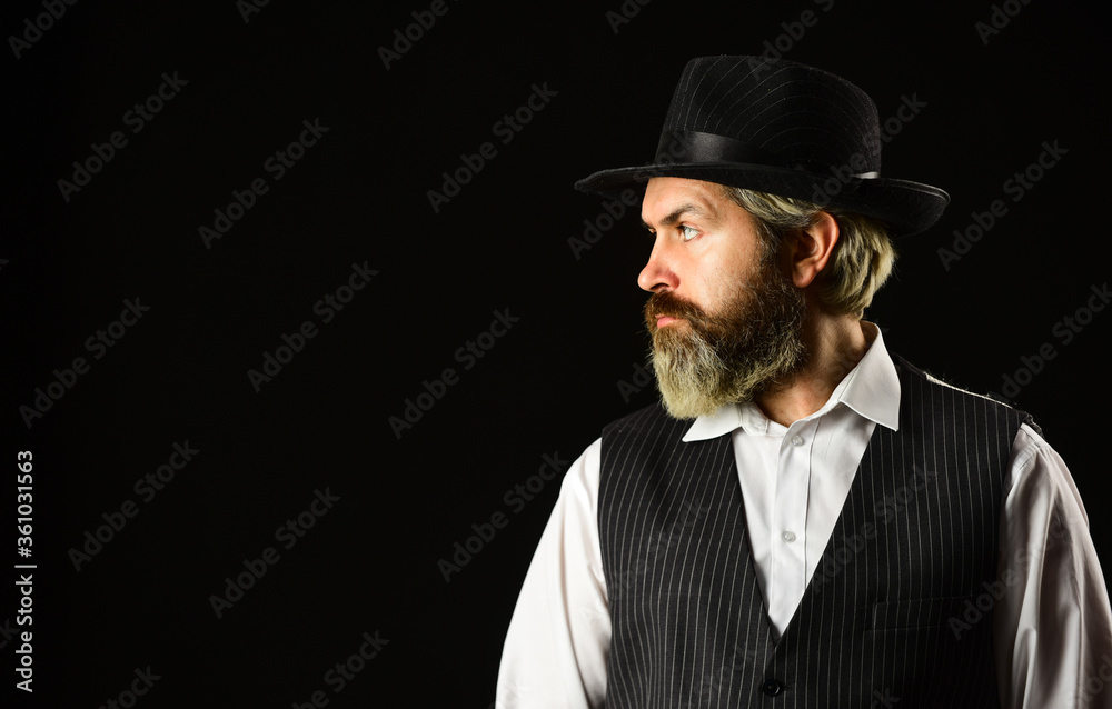 Man with retro Hat. brutal bearded hipster in suit vest. mafia gentlemen club. mature cowboy. detective acknowledgement or greeting. trilby hat. man in vintage style wide brimmed hat. copy space