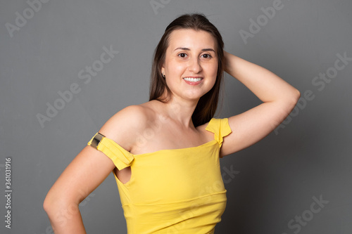 Happy young woman in a yellow dress. Portrait of a smiling girl.