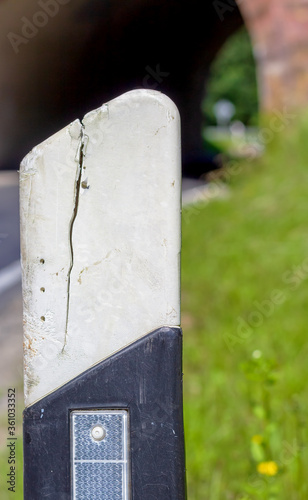 reflector of a defective road post, with long crack