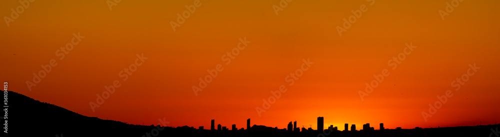 Spectacular Benidorm skyline at sunset with orange sky