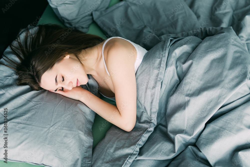 Young beautiful woman sleeping in her bed top view Young beautiful woman sleeping in her bed top view