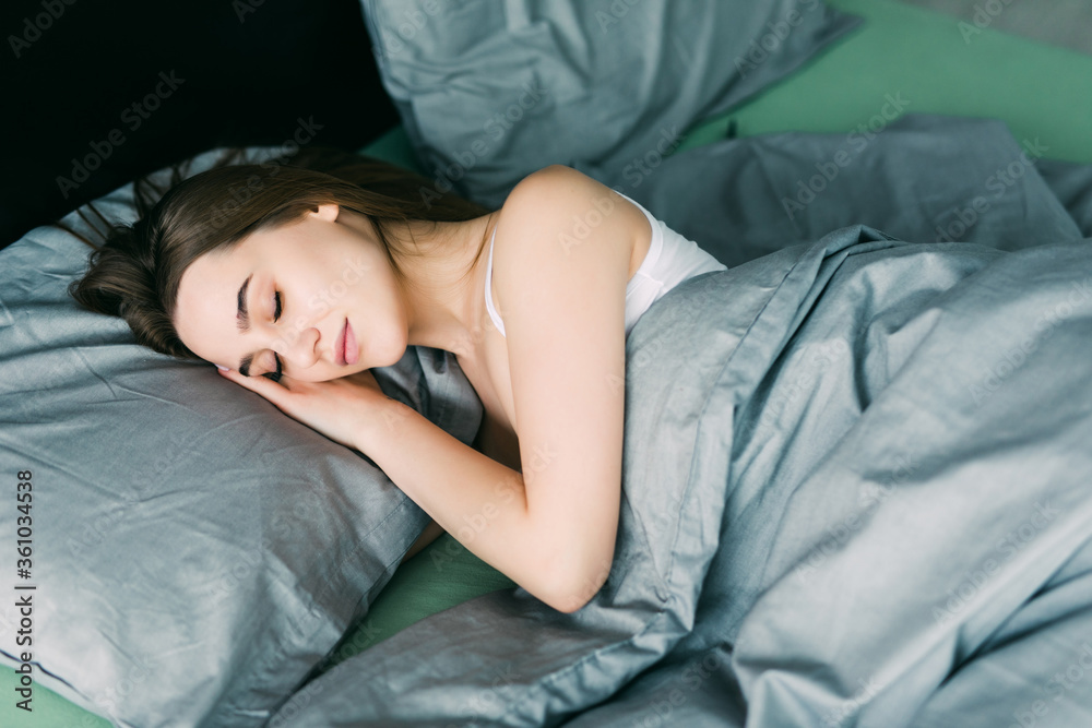 Young beautiful woman sleeping in her bed top view Young beautiful woman sleeping in her bed top view