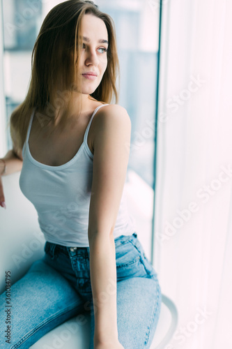 Young woman resting in chair at home near window © dianagrytsku