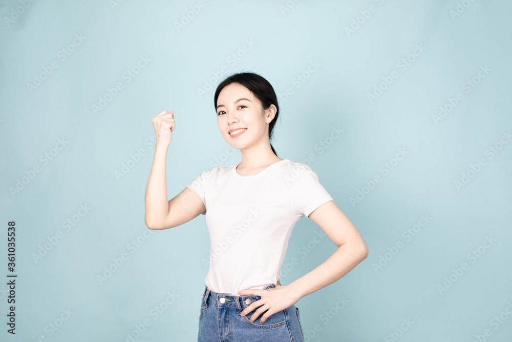 A young chinese woman in front of blue background A young chinese woman in front of blue background