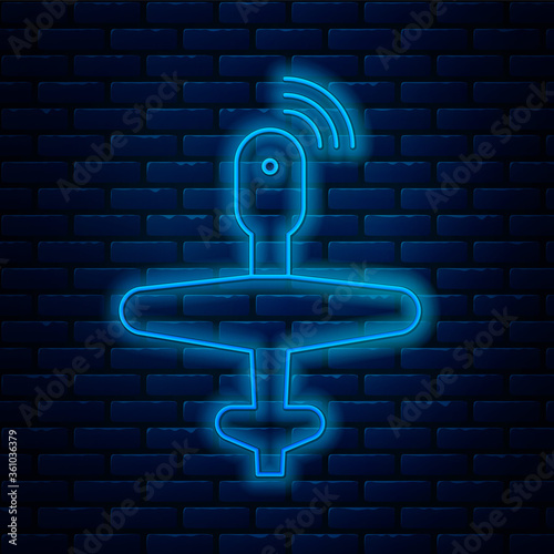Glowing neon line UAV Drone icon isolated on brick wall background. Military Unmanned aircraft spy. Vector Illustration.