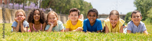 Portrait of smiling children who are posing lying in park photo