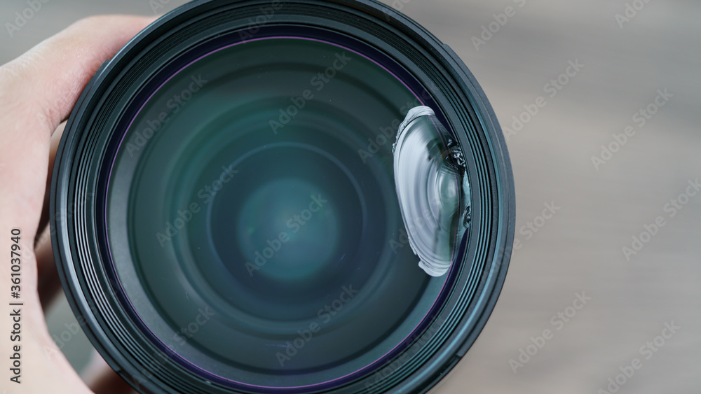 Broken mirrorless camera lens glass, accident dropped to the ground.