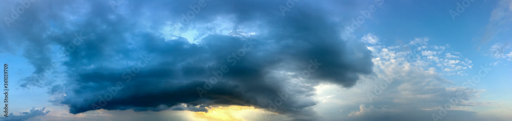 Fototapeta premium Stormy stormy sky with clouds at sunset, banner, panorama.
