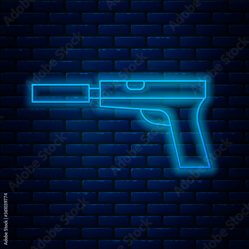 Glowing neon line Pistol or gun with silencer icon isolated on brick wall background. Vector Illustration.