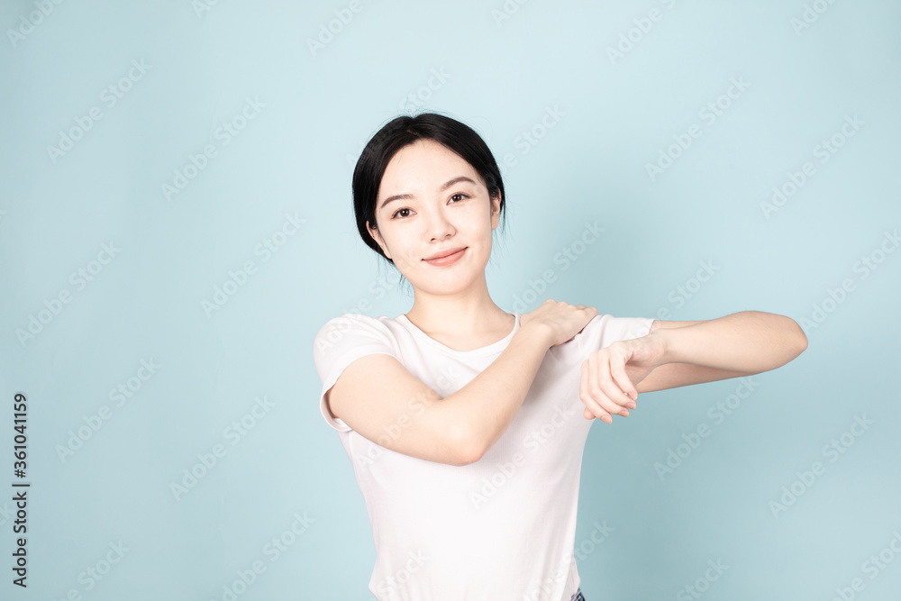 A young chinese woman in front of blue background A young chinese woman in front of blue background