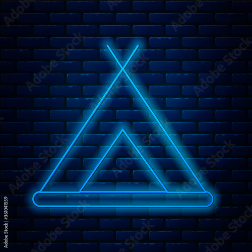 Glowing neon line Tourist tent icon isolated on brick wall background. Camping symbol. Vector Illustration.