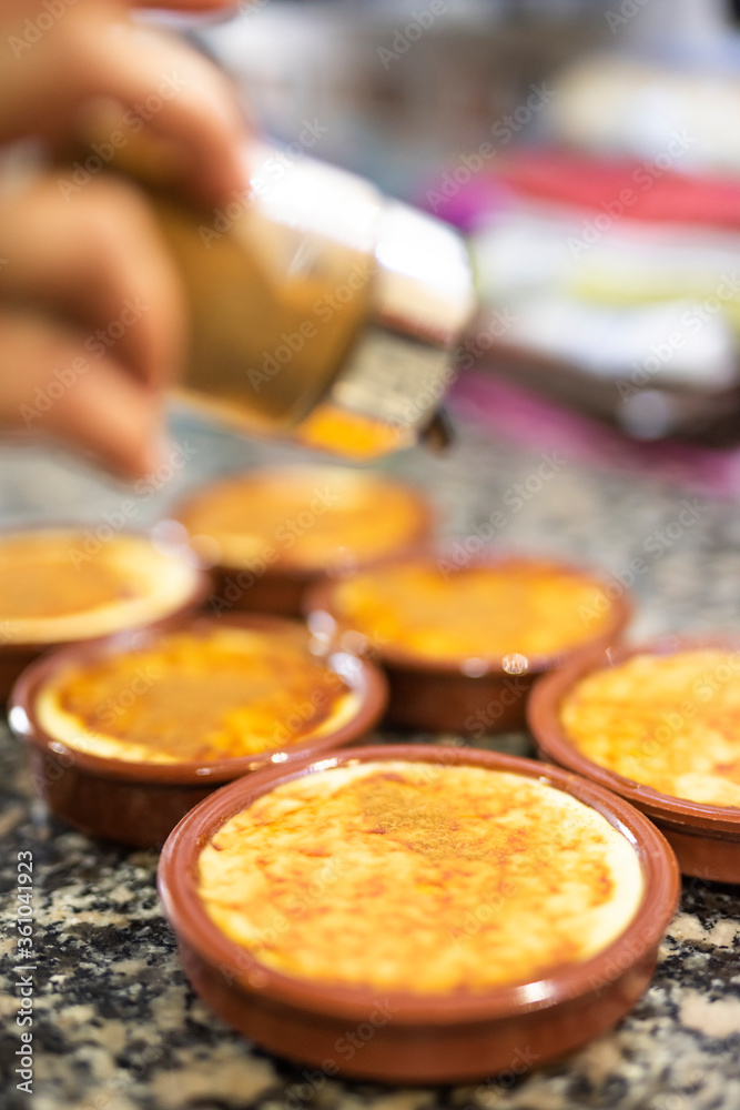 COOKING HOMEMADE CUSTARD AND PUTTING CINNAMON COOKING HOMEMADE CUSTARD AND PUTTING CINNAMON