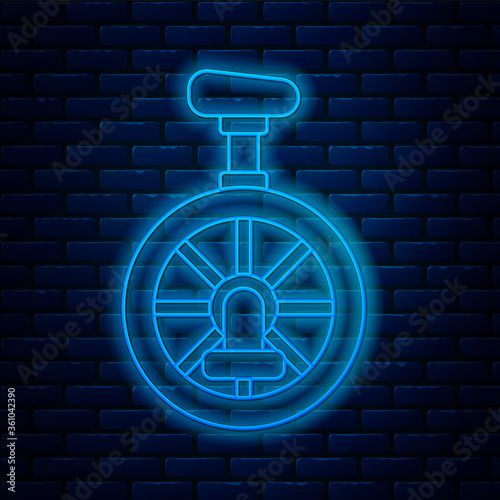 Glowing neon line Unicycle or one wheel bicycle icon isolated on brick wall background. Monowheel bicycle. Vector Illustration.