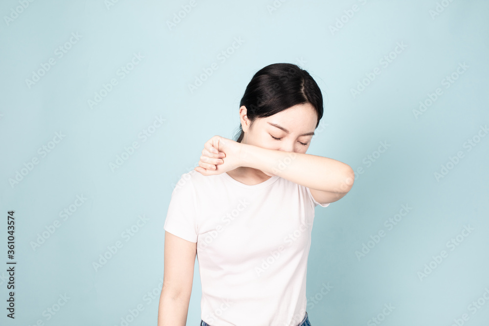 A young chinese woman in front of blue background A young chinese woman in front of blue background